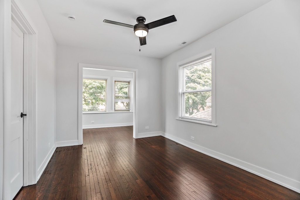 4313 West Parker Avenue Chicago, IL 60639 - Photo 4 of 17 a view of an empty room with wooden floor and a window