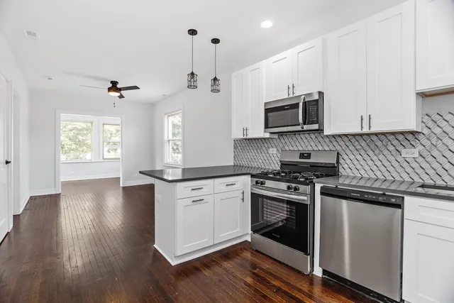a kitchen with a stove a sink and a microwave