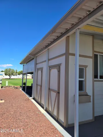 a view of a house with backyard and porch