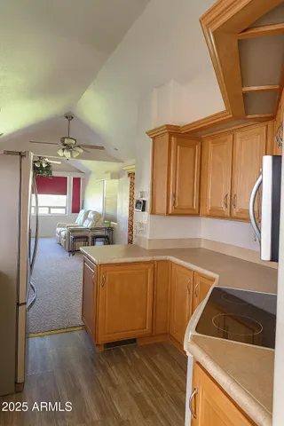 a kitchen with stainless steel appliances granite countertop a sink a stove and a refrigerator