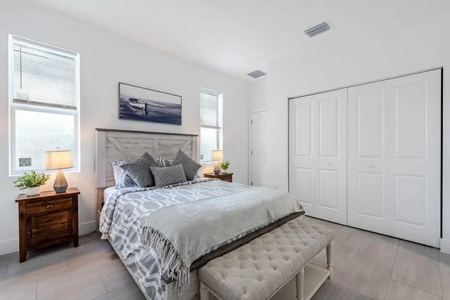 a bedroom with a bed and a painting on the wall