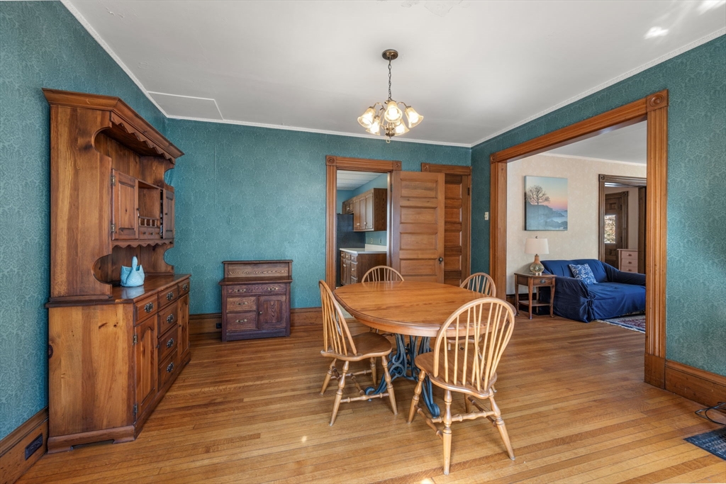 66 Jersey Street Marblehead, MA 01945 - Photo 16 of 31 a dining room with furniture a chandelier and wooden floor