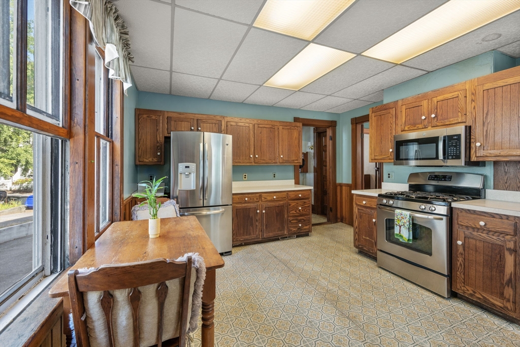 66 Jersey Street Marblehead, MA 01945 - Photo 20 of 31 a kitchen with stainless steel appliances granite countertop a stove a sink and a refrigerator
