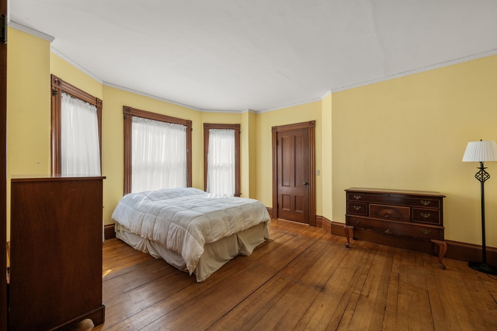 66 Jersey Street Marblehead, MA 01945 - Photo 27 of 31 a bedroom with a bed and wooden floor