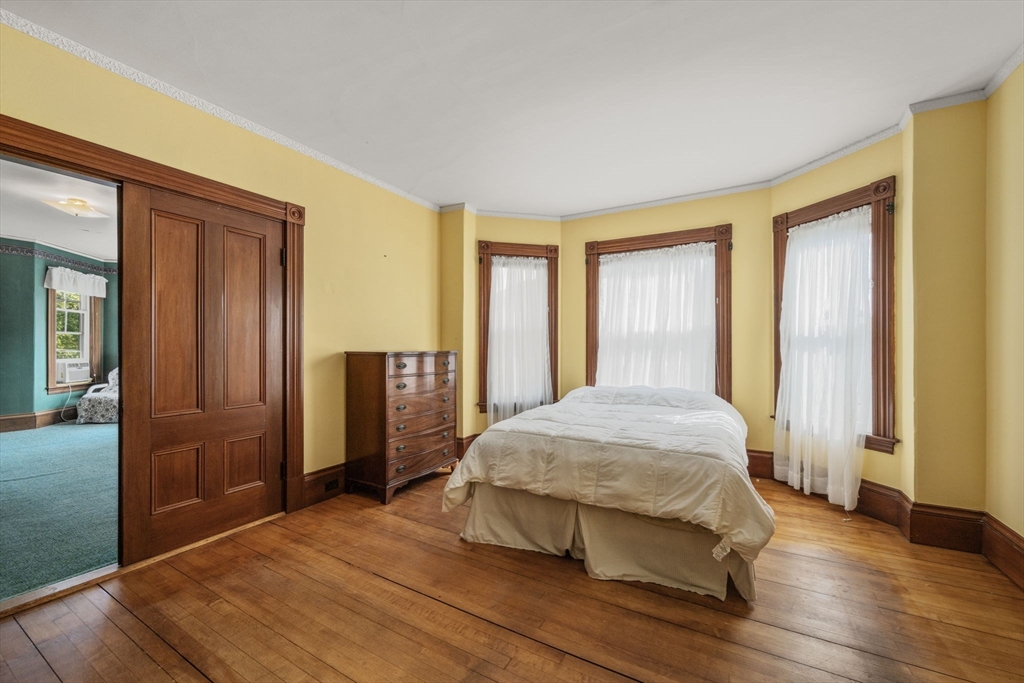 66 Jersey Street Marblehead, MA 01945 - Photo 28 of 31 a bedroom with a bed and wooden floor