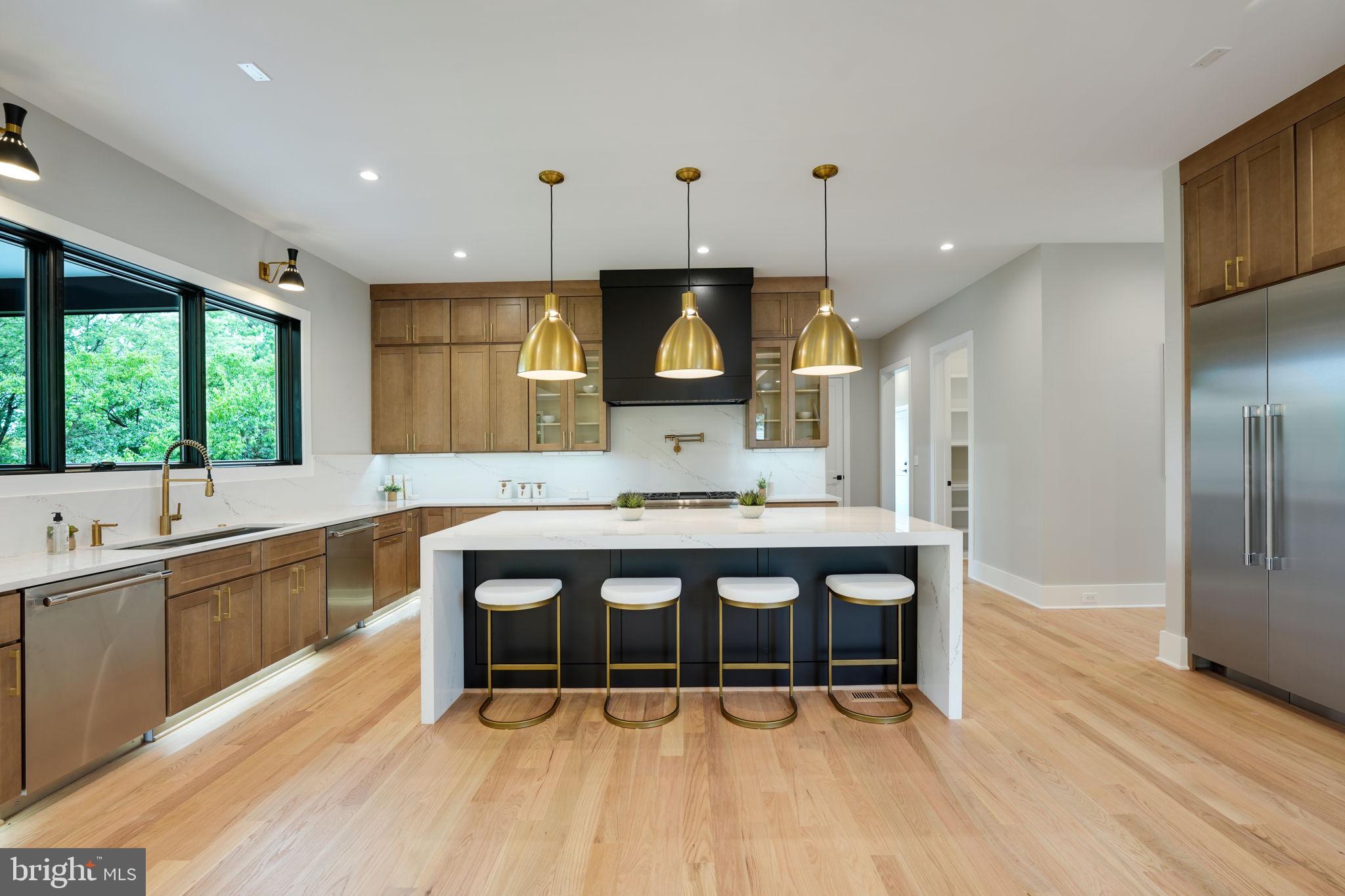 7925 Falstaff Road McLean, VA 22102 - Photo 15 of 58 a large kitchen with a table and chairs