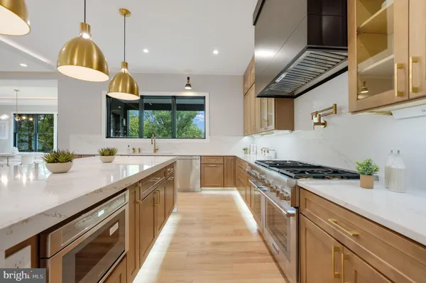 a kitchen with stainless steel appliances granite countertop a stove and a sink