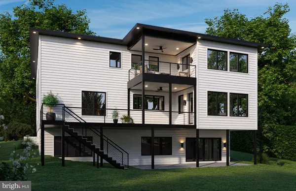 a front view of a house with a garden and deck