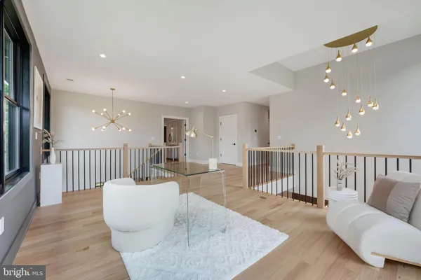 a spacious bedroom with a large bed and a chandelier