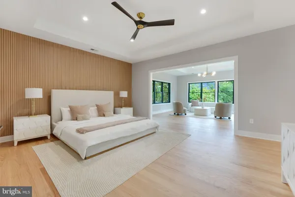 a spacious bedroom with a large bed and a large window