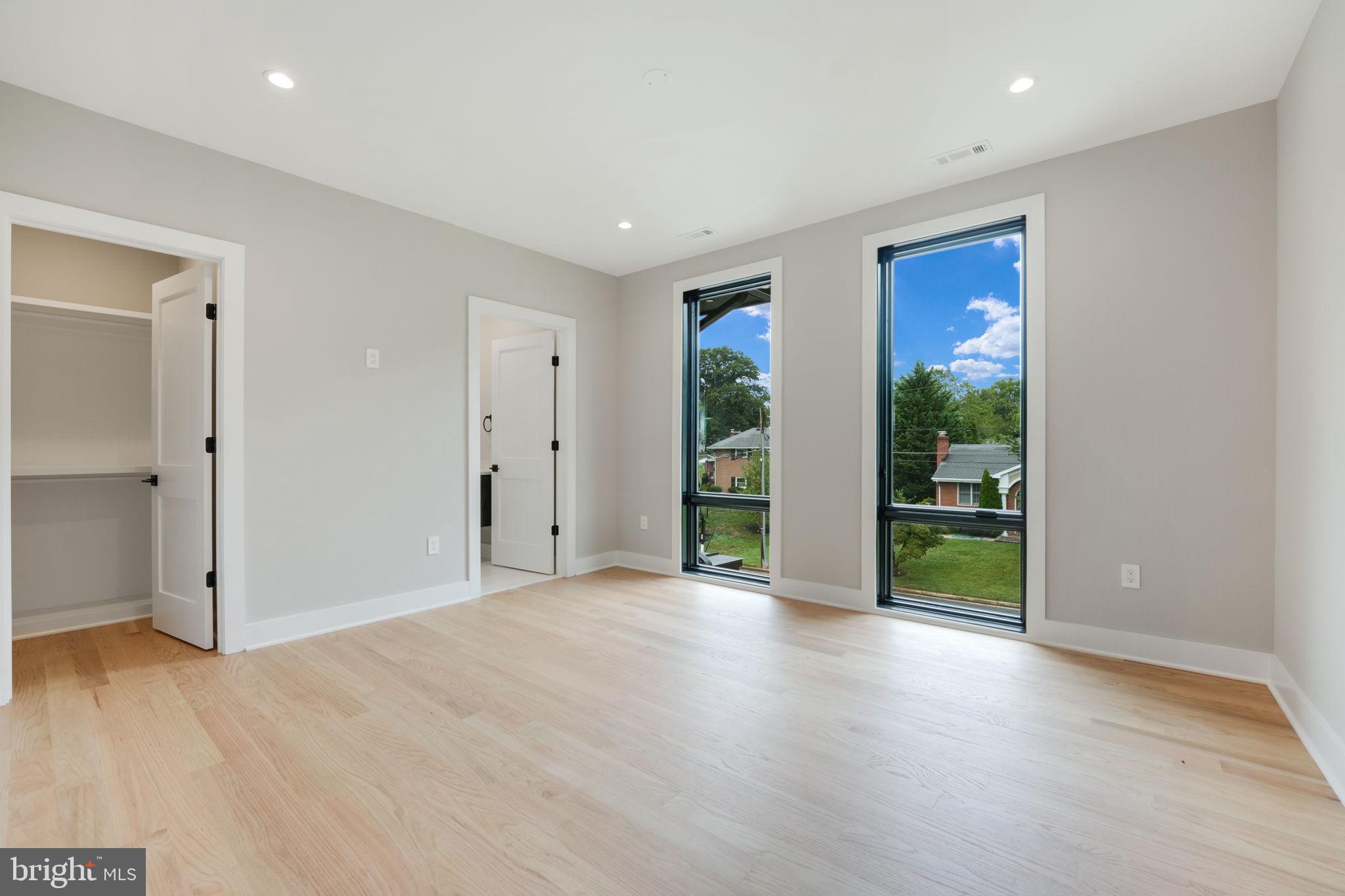 7925 Falstaff Road McLean, VA 22102 - Photo 38 of 58 an empty room with floor to ceiling window and wooden floor