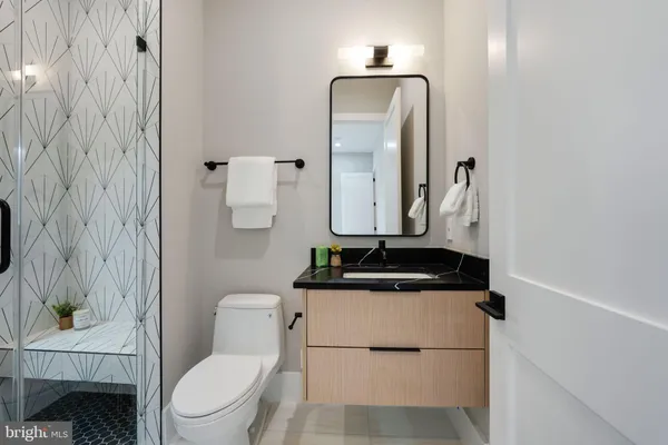 a bathroom with a toilet sink and mirror