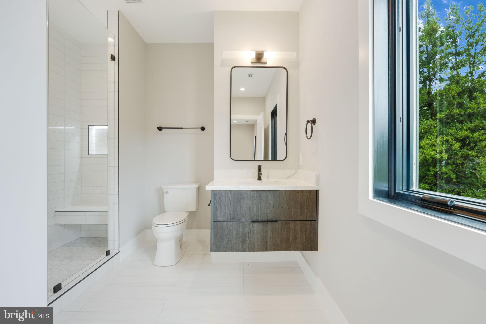 7925 Falstaff Road McLean, VA 22102 - Photo 42 of 58 a bathroom with a toilet sink and mirror