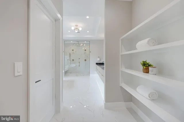 a view of an empty room with a fireplace and a window