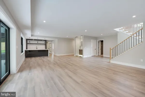 a kitchen with kitchen island a sink a stove and a refrigerator
