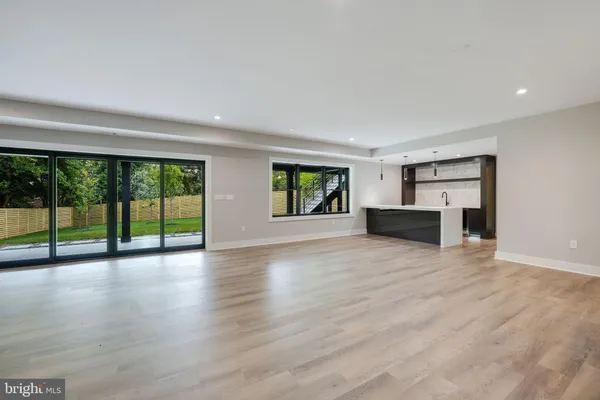 a view of front door with wooden floor and windows