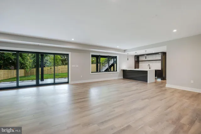 a view of front door with wooden floor and windows