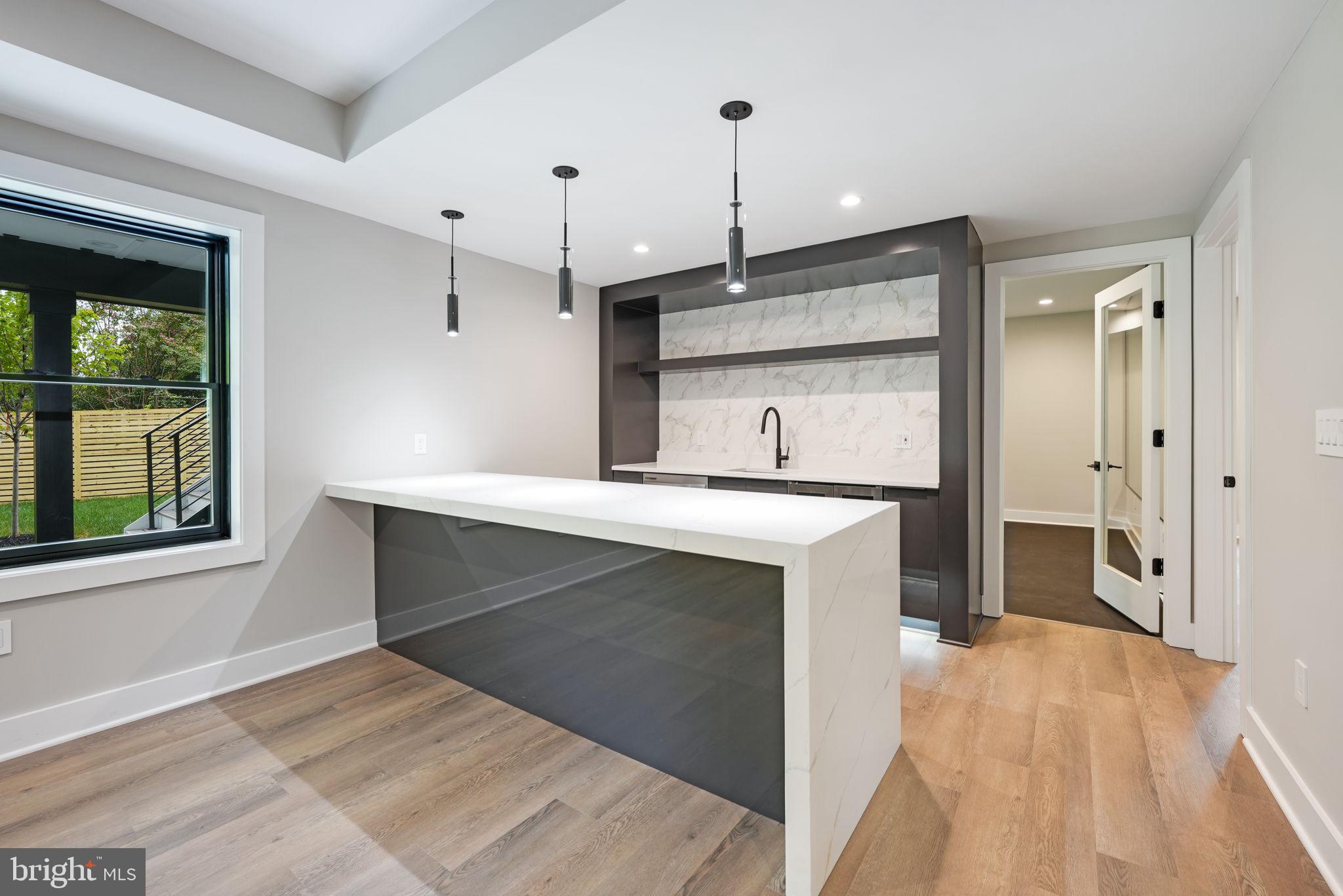 7925 Falstaff Road McLean, VA 22102 - Photo 53 of 58 a kitchen with kitchen island a sink a stove and a refrigerator