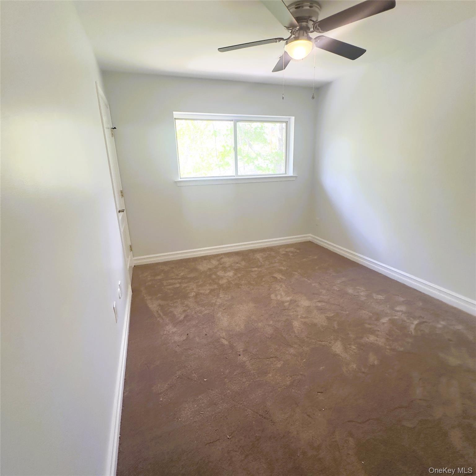 26 Cooper, Unit 603 Poughkeepsie, NY 12603 - Photo 10 of 15 an empty room with a window and a fan