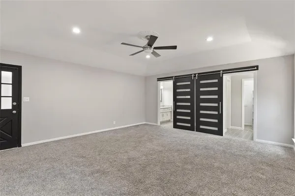 wooden floor in an empty room with a ceiling fan