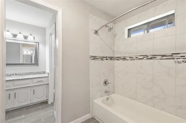 a bathroom with a bathtub and a shower