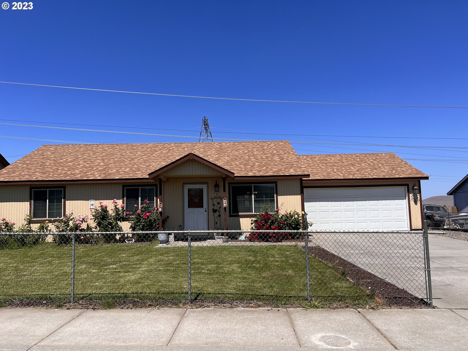 a front view of a house with a garden