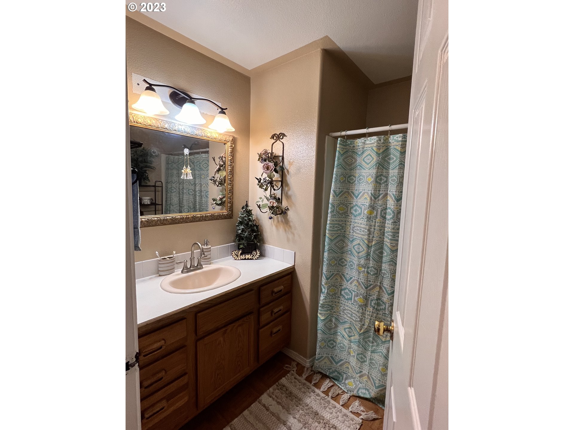 155 Pine Tree Avenue Umatilla, OR 97882 - Photo 11 of 15 a bathroom with a double vanity sink mirror and shower