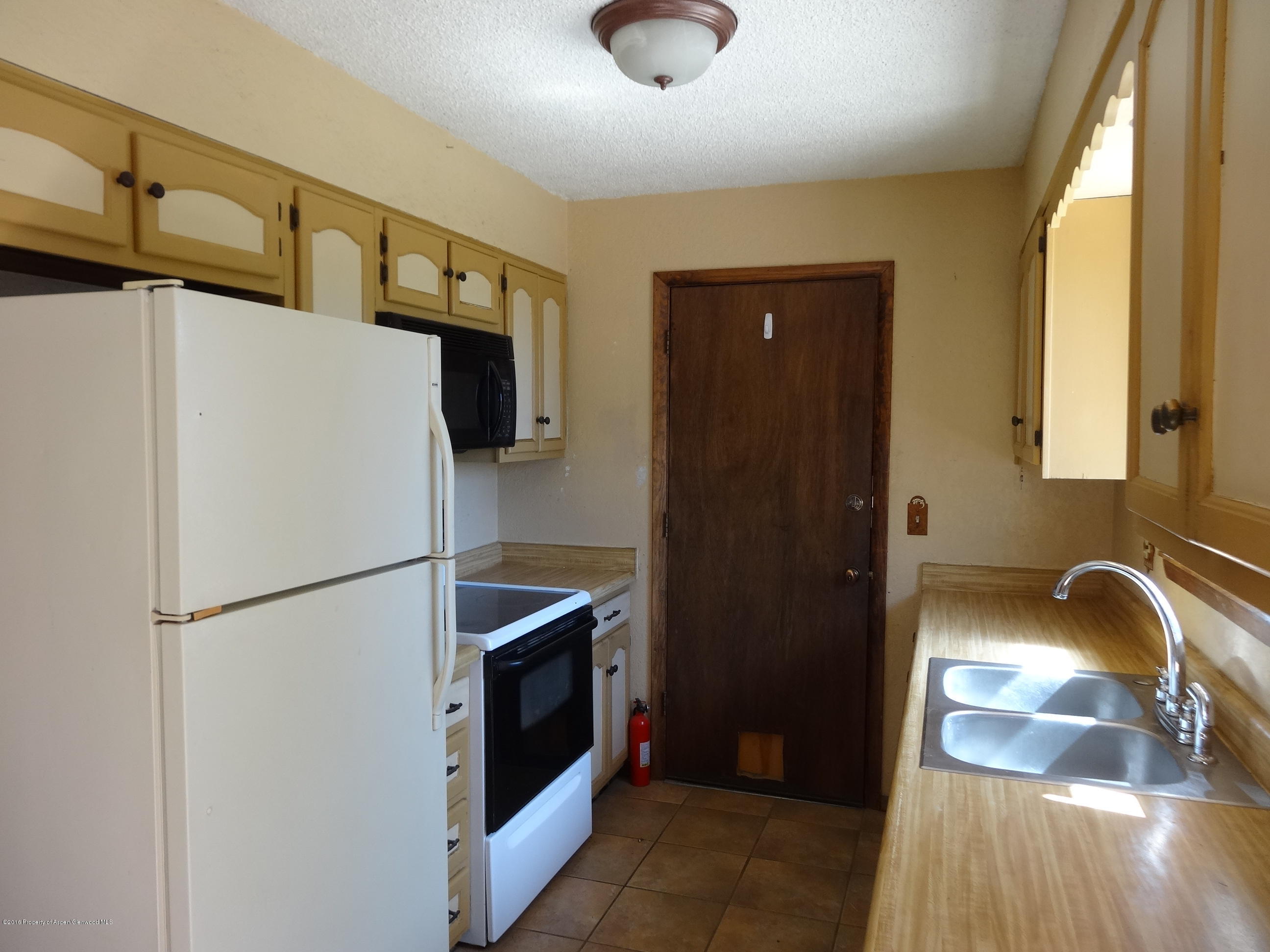 416 Will Avenue Rifle, CO 81650 - Photo 4 of 14 a kitchen with a refrigerator and a sink