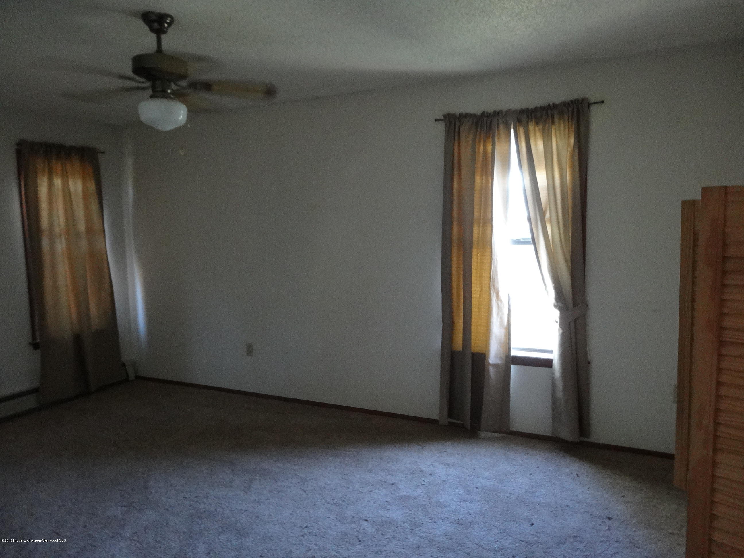 416 Will Avenue Rifle, CO 81650 - Photo 8 of 14 an empty room with windows and closet