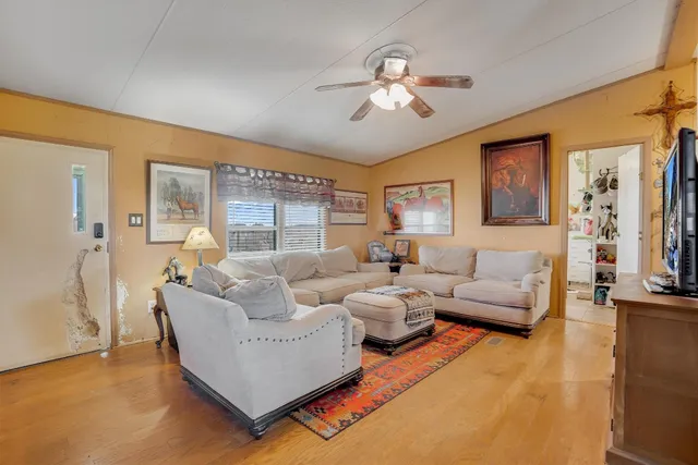 a living room with furniture and a chandelier