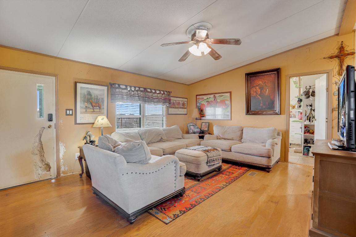 3007 County Road 303 Jarrell, TX 76537 - Photo 3 of 36 a living room with furniture and a chandelier