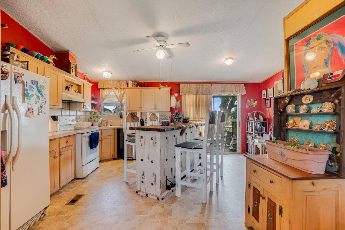 3007 County Road 303 Jarrell, TX 76537 - Photo 6 of 36 a kitchen with stainless steel appliances kitchen island granite countertop a sink and cabinets