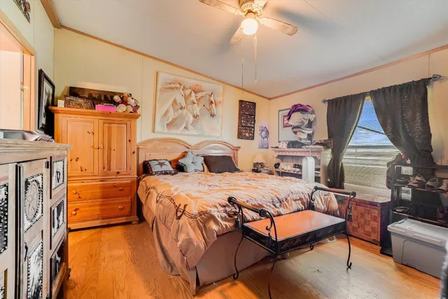 a spacious bedroom with a bed and a chandelier