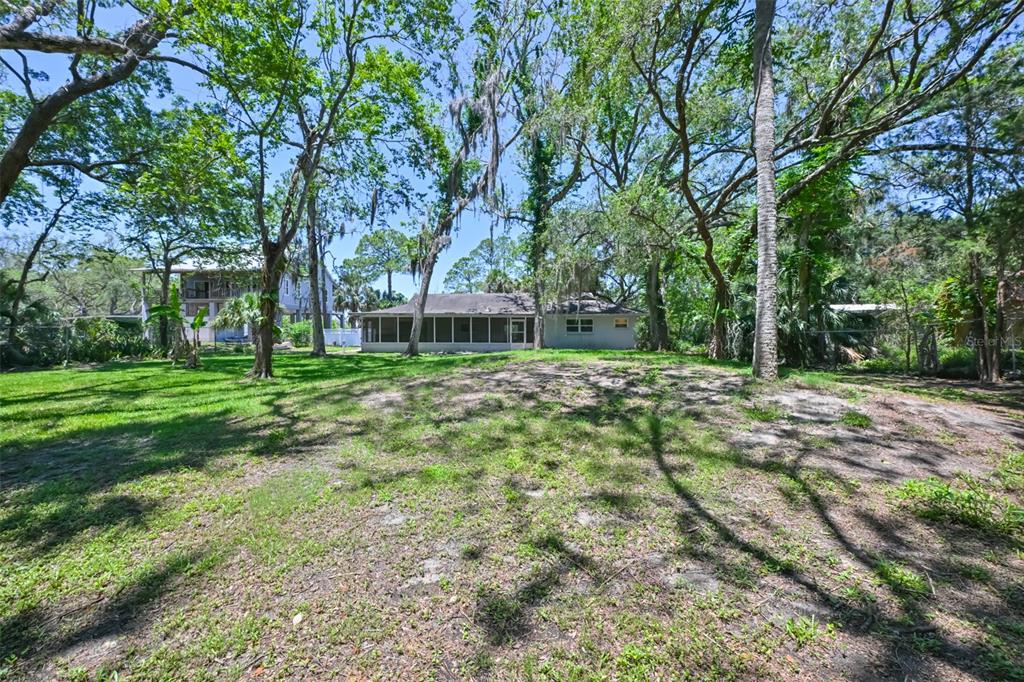 1578 Indian Bay Road Spring Hill, FL 34607 - Photo 40 of 51 a backyard of a house with lots of green space and fountain