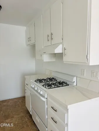 a kitchen with cabinets appliances and a sink