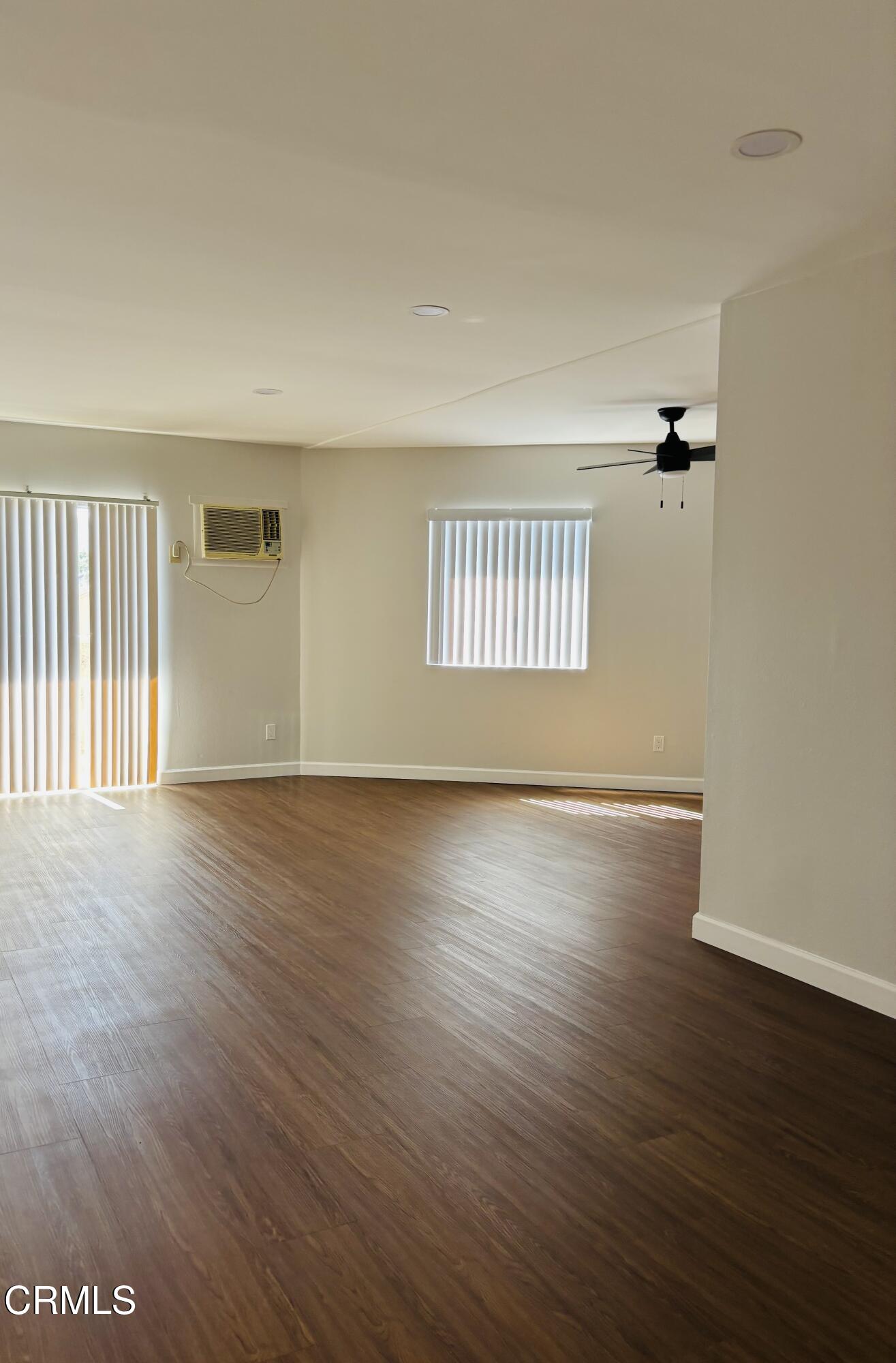 2750 Piedmont Avenue, Unit 22 Montrose, CA 91020 - Photo 4 of 10 an empty room with wooden floor and windows