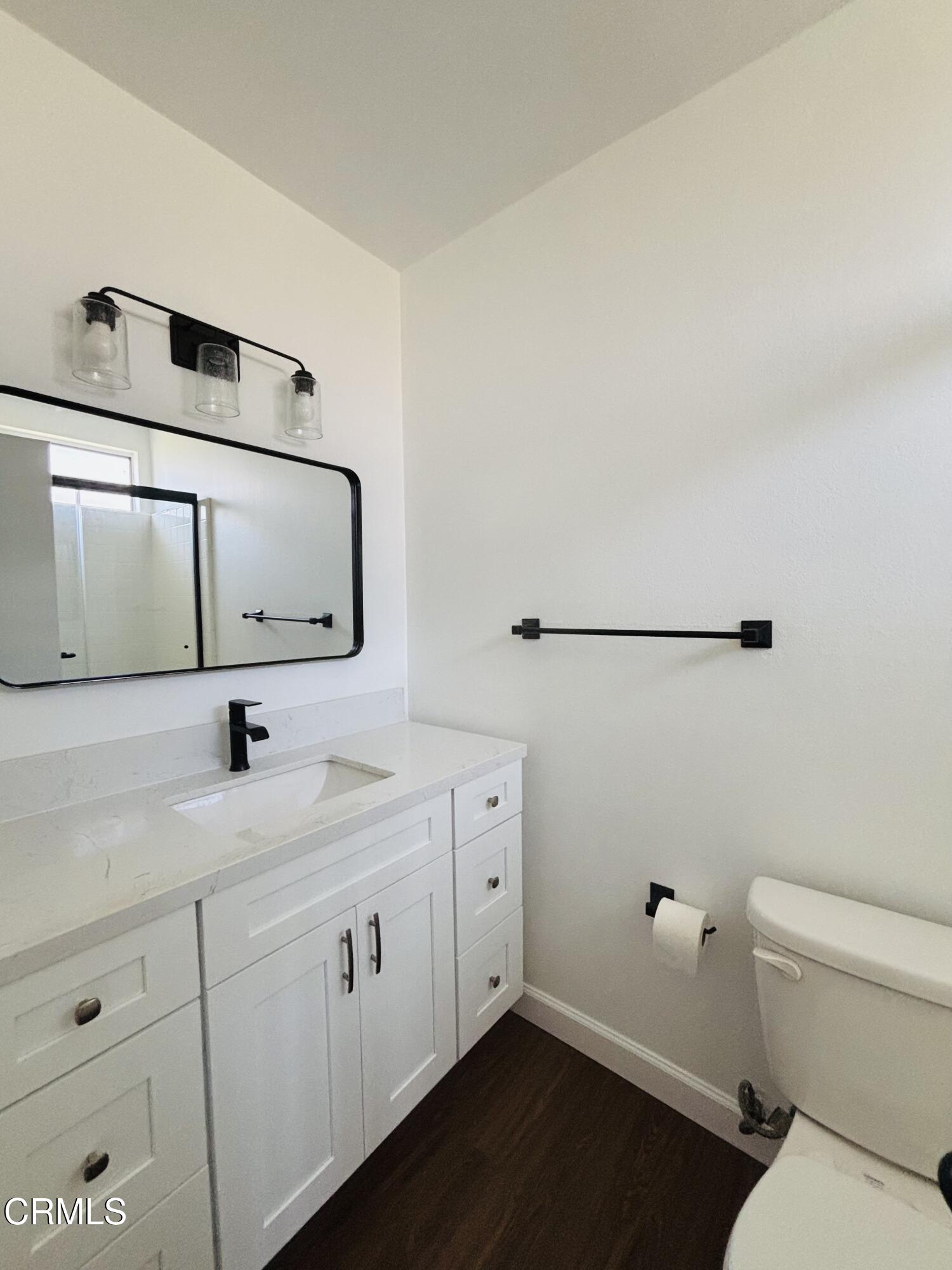 2750 Piedmont Avenue, Unit 22 Montrose, CA 91020 - Photo 9 of 10 a bathroom with a sink a toilet and mirror