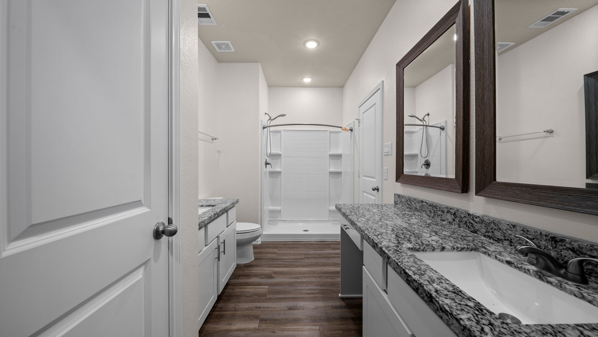 18140 Mail Rte Road Montgomery, TX 77316 - Photo 14 of 26 Enjoy a spa-inspired primary bathroom complete with dual sinks, granite countertops, and an oversized walk-in shower.