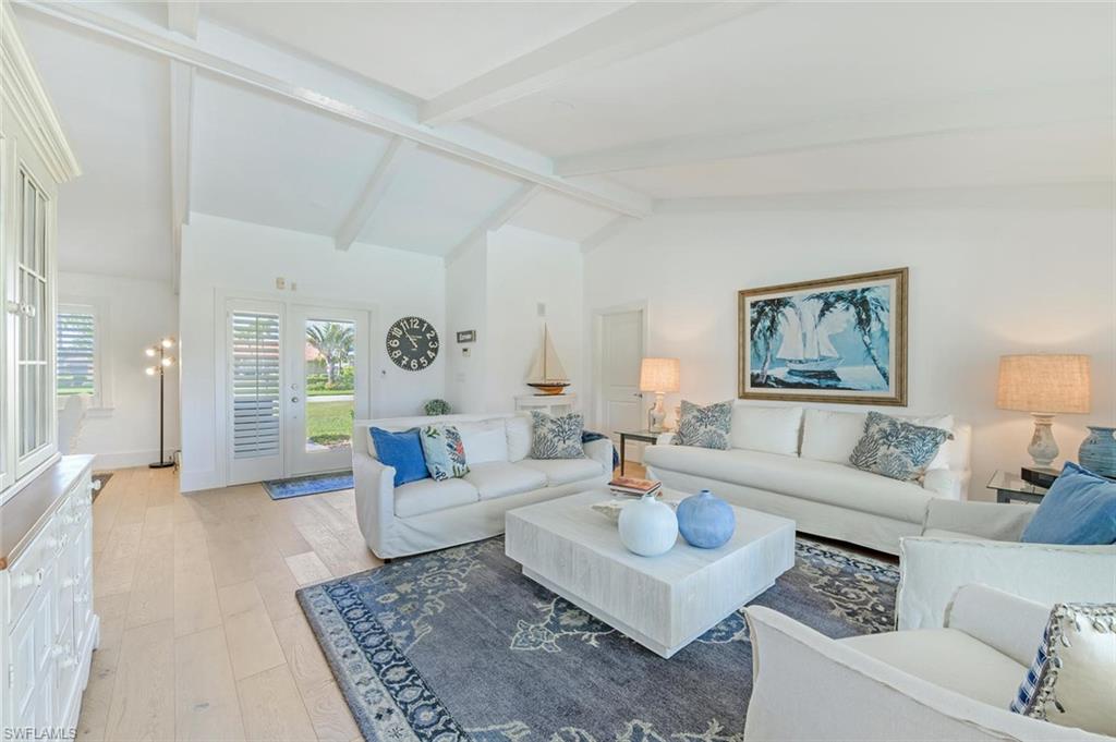 239 Torrey Pines Point Naples, FL 34113 - Photo 15 of 36 a living room with furniture and a rug