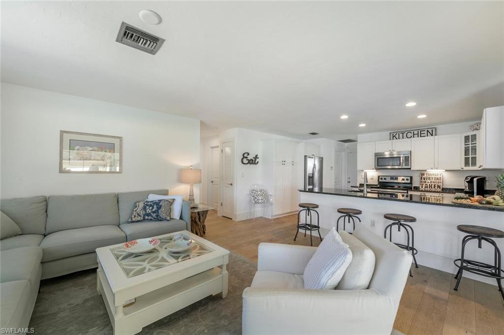 239 Torrey Pines Point Naples, FL 34113 - Photo 22 of 36 a living room with furniture kitchen view and a table