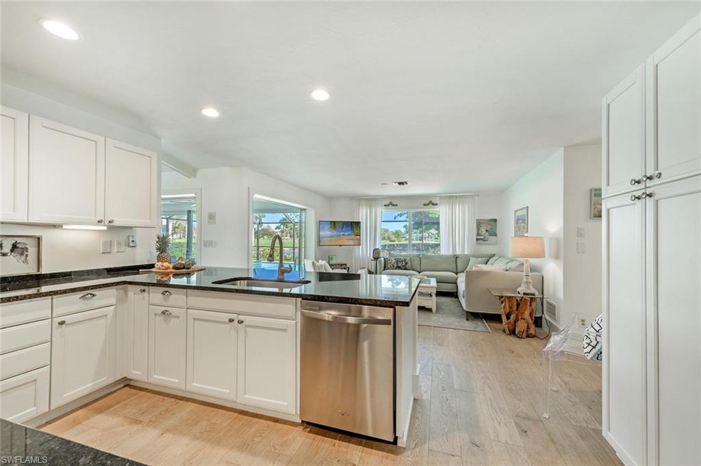 239 Torrey Pines Point Naples, FL 34113 - Photo 25 of 36 a kitchen with sink and cabinets
