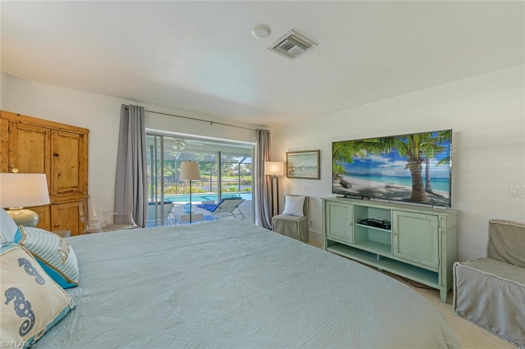 239 Torrey Pines Point Naples, FL 34113 - Photo 28 of 36 a bedroom with furniture and a flat screen tv