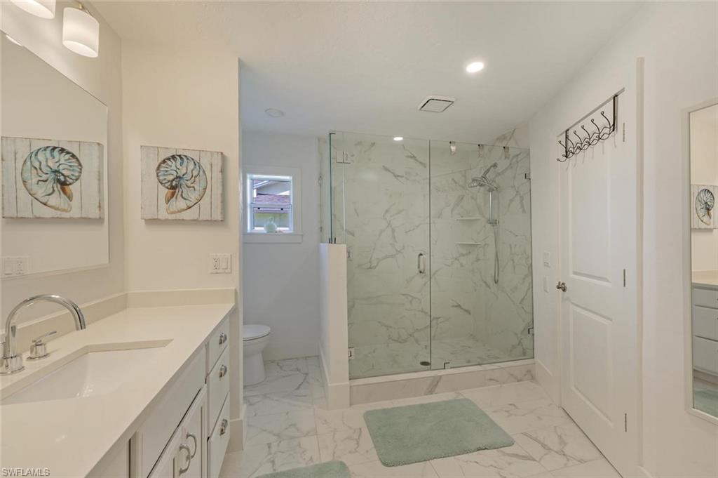 239 Torrey Pines Point Naples, FL 34113 - Photo 29 of 36 a bathroom with a sink a toilet and shower