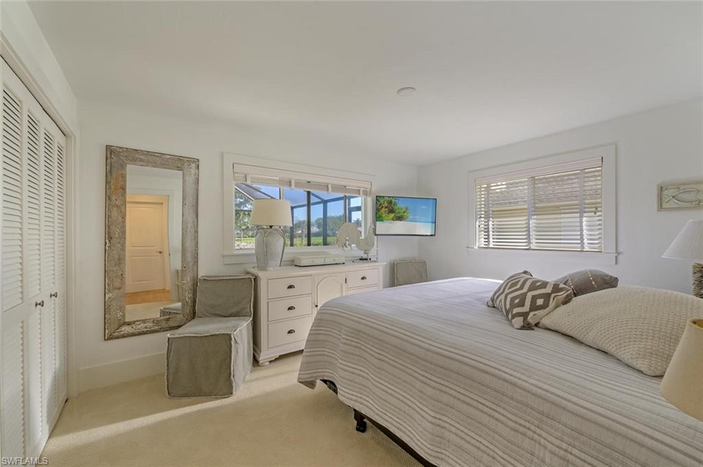 239 Torrey Pines Point Naples, FL 34113 - Photo 32 of 36 a bedroom with a bed and a dresser