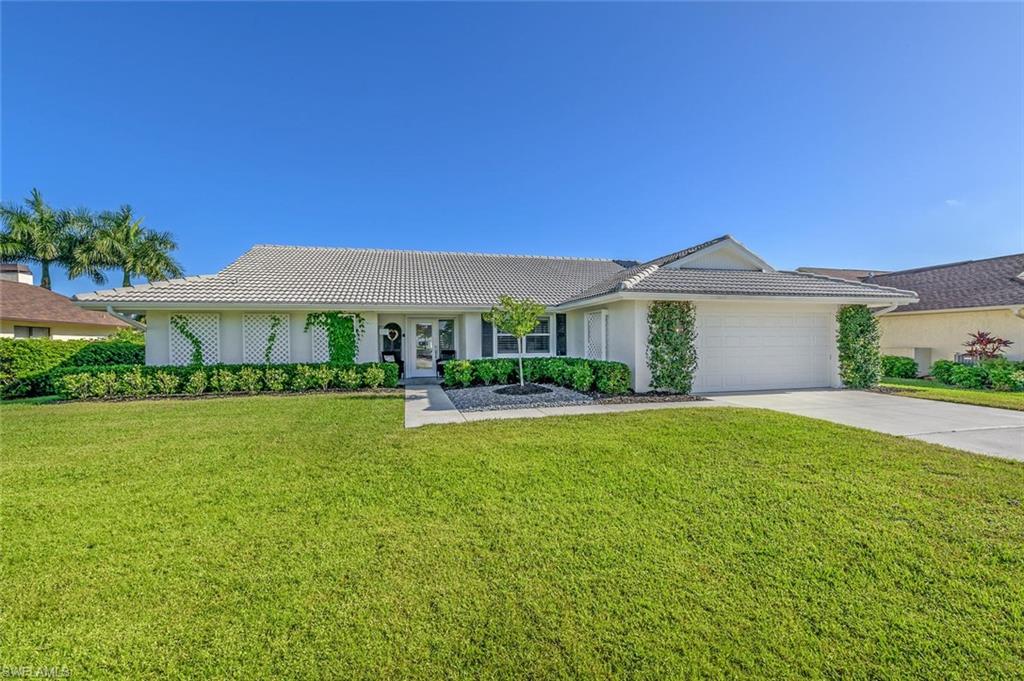 239 Torrey Pines Point Naples, FL 34113 - Photo 36 of 36 a front view of a house with a garden
