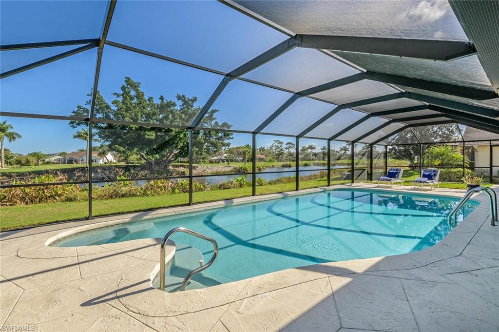 239 Torrey Pines Point Naples, FL 34113 - Photo 5 of 36 a view of a swimming pool with a lounge chairs