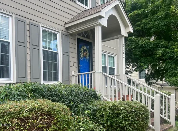 a view of a house with a yard and plants