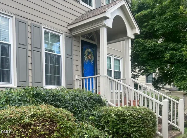 a view of a house with a yard and plants