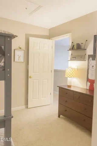 a room with a dresser and a window