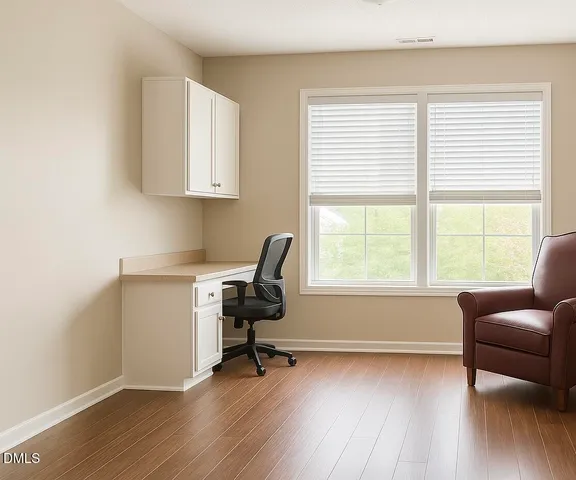 a livingroom with workspace and a window